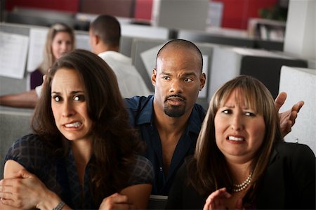Handsome African-American man stands behind uncomfortable woman employees Stock Photo - Budget Royalty-Free & Subscription, Code: 400-04405071