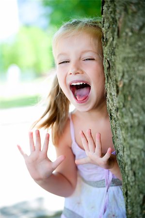 cute little girl smiling in a park close-up Stock Photo - Budget Royalty-Free & Subscription, Code: 400-04405188