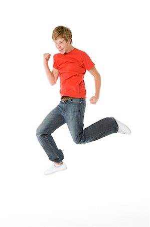 simsearch:400-04405553,k - Teenage Boy Jumping In The Air Stock Photo - Budget Royalty-Free & Subscription, Code: 400-04405560
