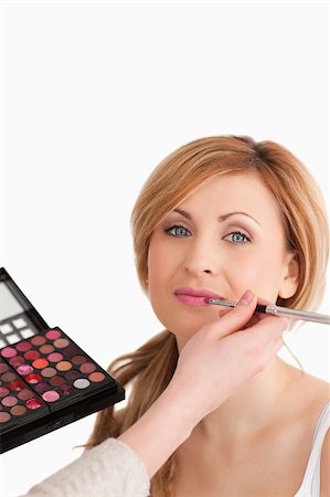 Young blond-haired woman having her make up done by a make up artist in a studio Stock Photo - Budget Royalty-Free & Subscription, Code: 400-04405852