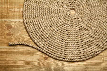 Roll of rough rope on wooden background Stock Photo - Budget Royalty-Free & Subscription, Code: 400-04407852