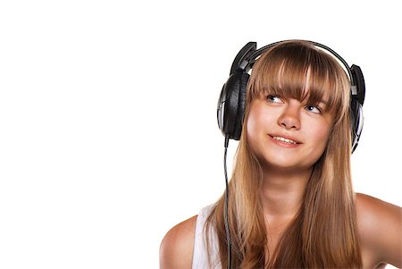 Lovely girl listening a music in headphones, white background Fotografie stock - Microstock e Abbonamento, Codice: 400-04408051