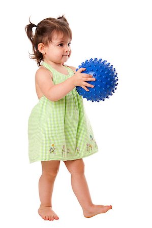 phakimata (artist) - Beautiful cute happy toddler baby girl in green dress walking playing with blue spiky ball, isolated. Stockbilder - Microstock & Abonnement, Bildnummer: 400-04409624