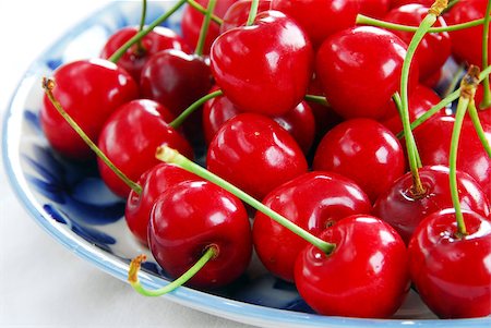 simsearch:400-06855989,k - appetizing red fresh ripe cherries on blue plate Photographie de stock - Aubaine LD & Abonnement, Code: 400-04409677