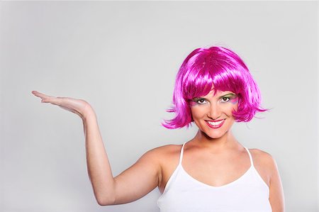 funny wig woman - A picture of a pretty woman in a purple wig presenting your product over light background Stock Photo - Budget Royalty-Free & Subscription, Code: 400-04409827