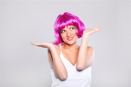 funny wig woman - A picture of a pretty woman in a purple wig presenting your product over light background Stock Photo - Budget Royalty-Free & Subscription, Code: 400-04409833