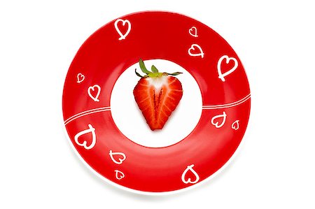 simsearch:400-05265200,k - Deliciously half a red strawberry on the romantic red plate Photographie de stock - Aubaine LD & Abonnement, Code: 400-04400317