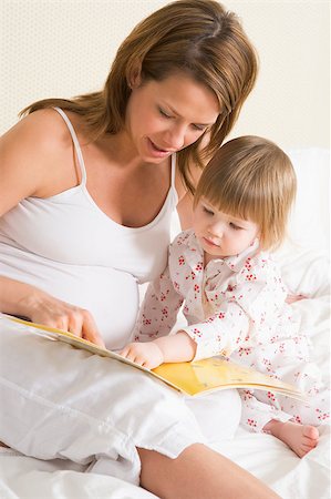 pregnant mom reading - Pregnant woman in bedroom reading book with daughter Stock Photo - Budget Royalty-Free & Subscription, Code: 400-04400472