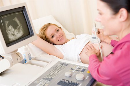 pregnant scan - Pregnant woman getting ultrasound from doctor Foto de stock - Super Valor sin royalties y Suscripción, Código: 400-04400679