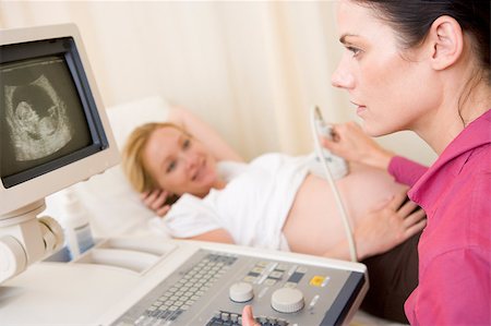 pregnant scan - Pregnant woman getting ultrasound from doctor Foto de stock - Super Valor sin royalties y Suscripción, Código: 400-04400680