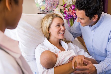 doctor speak with pregnant - New parents with baby talking to doctor and smiling Stock Photo - Budget Royalty-Free & Subscription, Code: 400-04400717