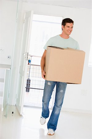 Man with box moving into new home smiling Stock Photo - Budget Royalty-Free & Subscription, Code: 400-04400768