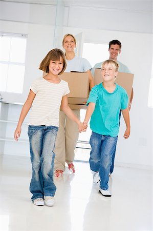 simsearch:400-09122233,k - Family with boxes moving into new home smiling Stock Photo - Budget Royalty-Free & Subscription, Code: 400-04400782