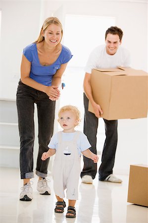 simsearch:400-08938320,k - Family moving into new home smiling Stock Photo - Budget Royalty-Free & Subscription, Code: 400-04400810