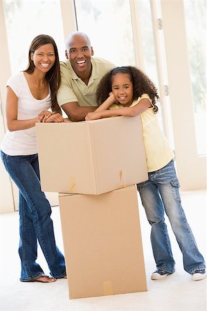 simsearch:400-08938320,k - Family with boxes in new home smiling Stock Photo - Budget Royalty-Free & Subscription, Code: 400-04400876