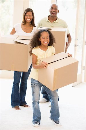 simsearch:400-08938320,k - Family moving into new home smiling Stock Photo - Budget Royalty-Free & Subscription, Code: 400-04400873