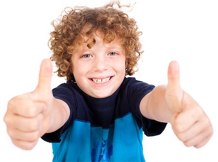 simsearch:400-06795514,k - Smiling cute little boy gesturing thumbs up sign against white background. Photographie de stock - Aubaine LD & Abonnement, Code: 400-04401004