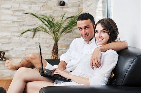 joyful couple relax and work on laptop computer at modern livingroom indoor home Stock Photo - Budget Royalty-Free & Subscription, Code: 400-04401176