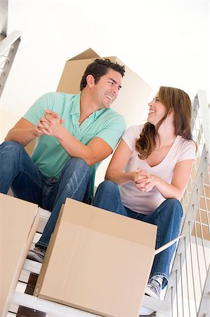 simsearch:400-04047615,k - Couple sitting on staircase with boxes in new home smiling Foto de stock - Super Valor sin royalties y Suscripción, Código: 400-04401419