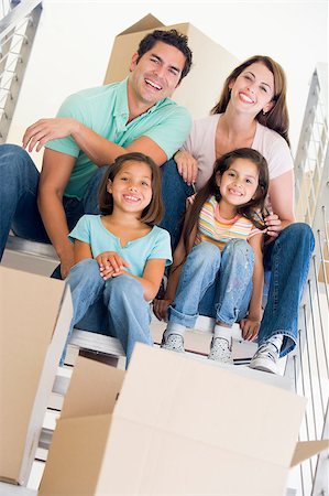 simsearch:400-08838107,k - Family sitting on staircase with boxes in new home smiling Foto de stock - Super Valor sin royalties y Suscripción, Código: 400-04401421