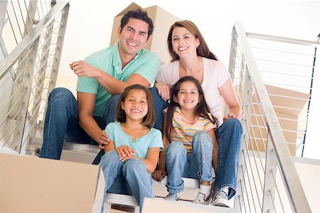 simsearch:400-04047615,k - Family sitting on staircase with boxes in new home smiling Foto de stock - Super Valor sin royalties y Suscripción, Código: 400-04401422