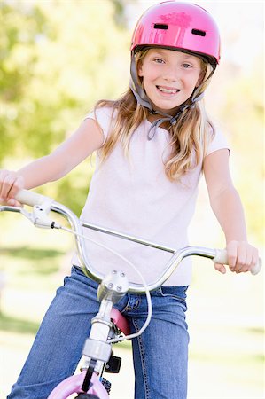 simsearch:400-04402100,k - Young girl on bicycle outdoors smiling Stock Photo - Budget Royalty-Free & Subscription, Code: 400-04402096