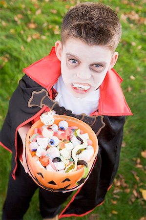 fearsome - Young boy outdoors wearing vampire costume on Halloween holding Stock Photo - Budget Royalty-Free & Subscription, Code: 400-04402154