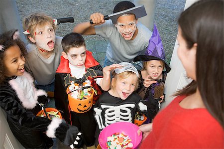 Six children in costumes trick or treating at woman's house Stock Photo - Budget Royalty-Free & Subscription, Code: 400-04402207