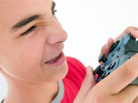 simsearch:400-05059261,k - Teenage boy using videogame controller Stock Photo - Budget Royalty-Free & Subscription, Code: 400-04402264