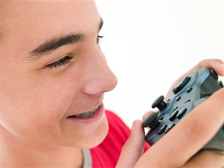simsearch:400-05059261,k - Teenage boy using videogame controller Stock Photo - Budget Royalty-Free & Subscription, Code: 400-04402265