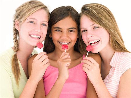Three girl friends with suckers smiling Stock Photo - Budget Royalty-Free & Subscription, Code: 400-04402289