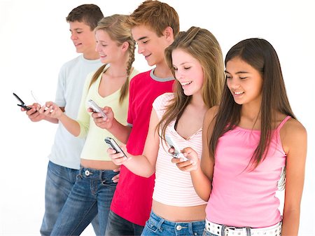 simsearch:400-04402293,k - Row of five friends using cellular phones smiling Stock Photo - Budget Royalty-Free & Subscription, Code: 400-04402296