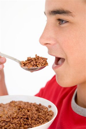 simsearch:400-04402341,k - Boy eating chocolate puff cereal Stock Photo - Budget Royalty-Free & Subscription, Code: 400-04402316