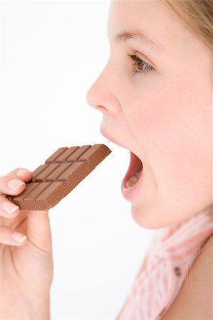 simsearch:400-04402341,k - Teenage girl eating chocolate bar Stock Photo - Budget Royalty-Free & Subscription, Code: 400-04402317
