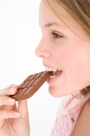 simsearch:400-04402341,k - Teenage girl eating chocolate bar Stock Photo - Budget Royalty-Free & Subscription, Code: 400-04402318