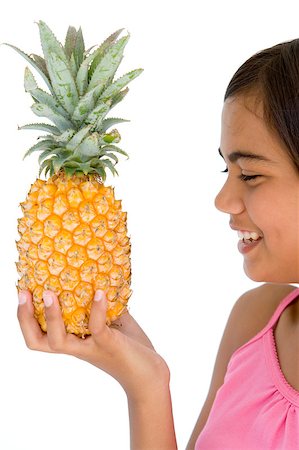 simsearch:400-04402342,k - Young girl holding pineapple and smiling Stock Photo - Budget Royalty-Free & Subscription, Code: 400-04402312