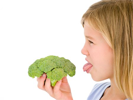 Young girl holding broccoli and sticking tongue out Stock Photo - Budget Royalty-Free & Subscription, Code: 400-04402342