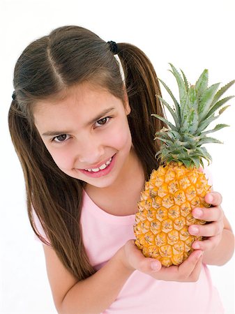 simsearch:400-04402342,k - Young girl holding pineapple and smiling Stock Photo - Budget Royalty-Free & Subscription, Code: 400-04402350