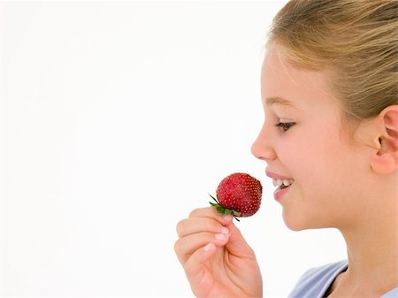 simsearch:400-04402341,k - Young girl eating strawberry smiling Stock Photo - Budget Royalty-Free & Subscription, Code: 400-04402364