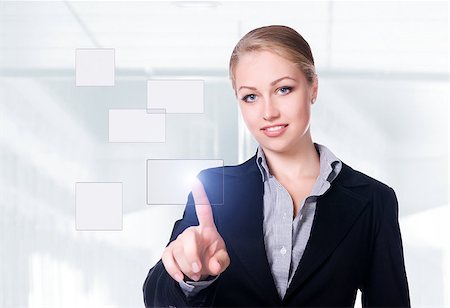businesswoman pressing a touchscreen button on a office background Stock Photo - Budget Royalty-Free & Subscription, Code: 400-04402493