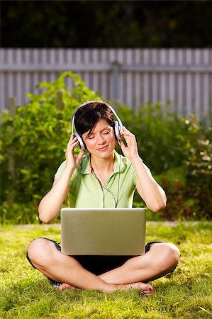 photo of people sit listening to radio - caucasian woman is sitting on the grass wearing headphones Stock Photo - Budget Royalty-Free & Subscription, Code: 400-04403052