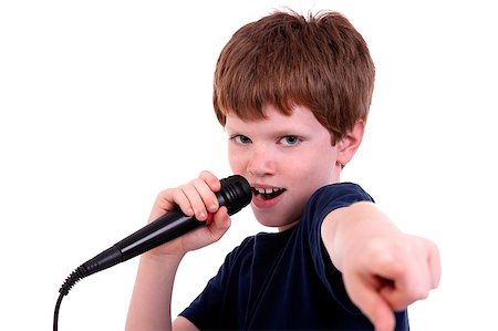 Cute boy with a microphone sings isolated on white, studio shot Stock Photo - Budget Royalty-Free & Subscription, Code: 400-04403303