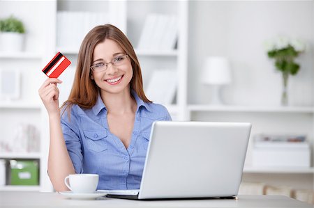 An attractive young girl with laptop and credit card Stock Photo - Budget Royalty-Free & Subscription, Code: 400-04414329