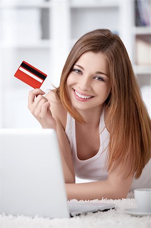 A young girl with a laptop and a credit card at home Stock Photo - Budget Royalty-Free & Subscription, Code: 400-04414333