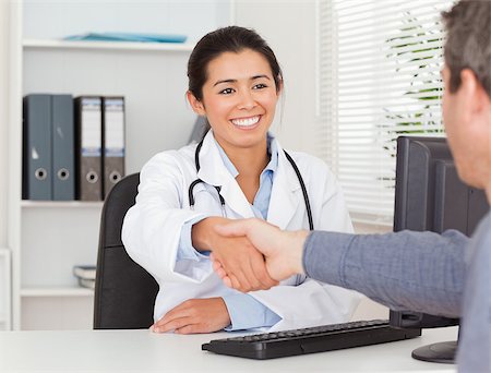 simsearch:400-05350424,k - Beautiful female doctor shaking a patient's hands in her office Foto de stock - Super Valor sin royalties y Suscripción, Código: 400-04415075