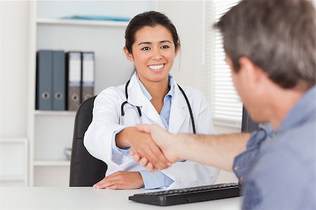 person suit hospital - Pretty female doctor shaking a patient's hands in her office Stock Photo - Budget Royalty-Free & Subscription, Code: 400-04415073