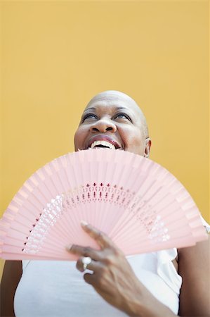 photo bald woman head - portrait of african 50 years old woman with bald head smiling on yellow background and looking up. Head and shoulders, copy space Stock Photo - Budget Royalty-Free & Subscription, Code: 400-04415253