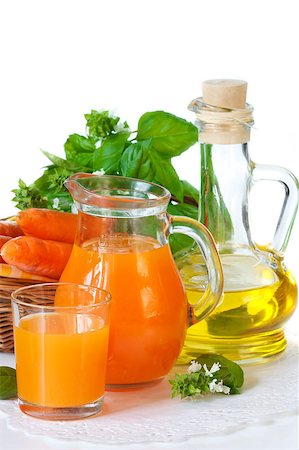 Homemade carrot juice in a glass jug with fresh basil and olive oil. Stock Photo - Budget Royalty-Free & Subscription, Code: 400-04415345