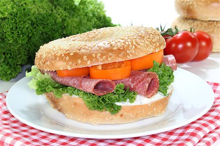 sesame bagel - Bagel topped with a salami and bell peppers Foto de stock - Super Valor sin royalties y Suscripción, Código: 400-04415563