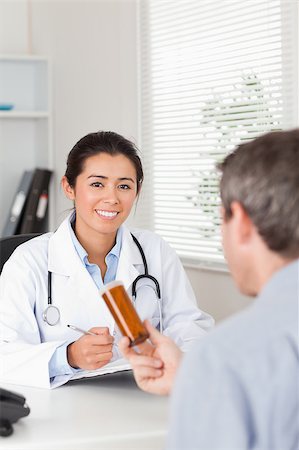 Patient holding a box of pills given by his doctor in the office Stock Photo - Budget Royalty-Free & Subscription, Code: 400-04415847